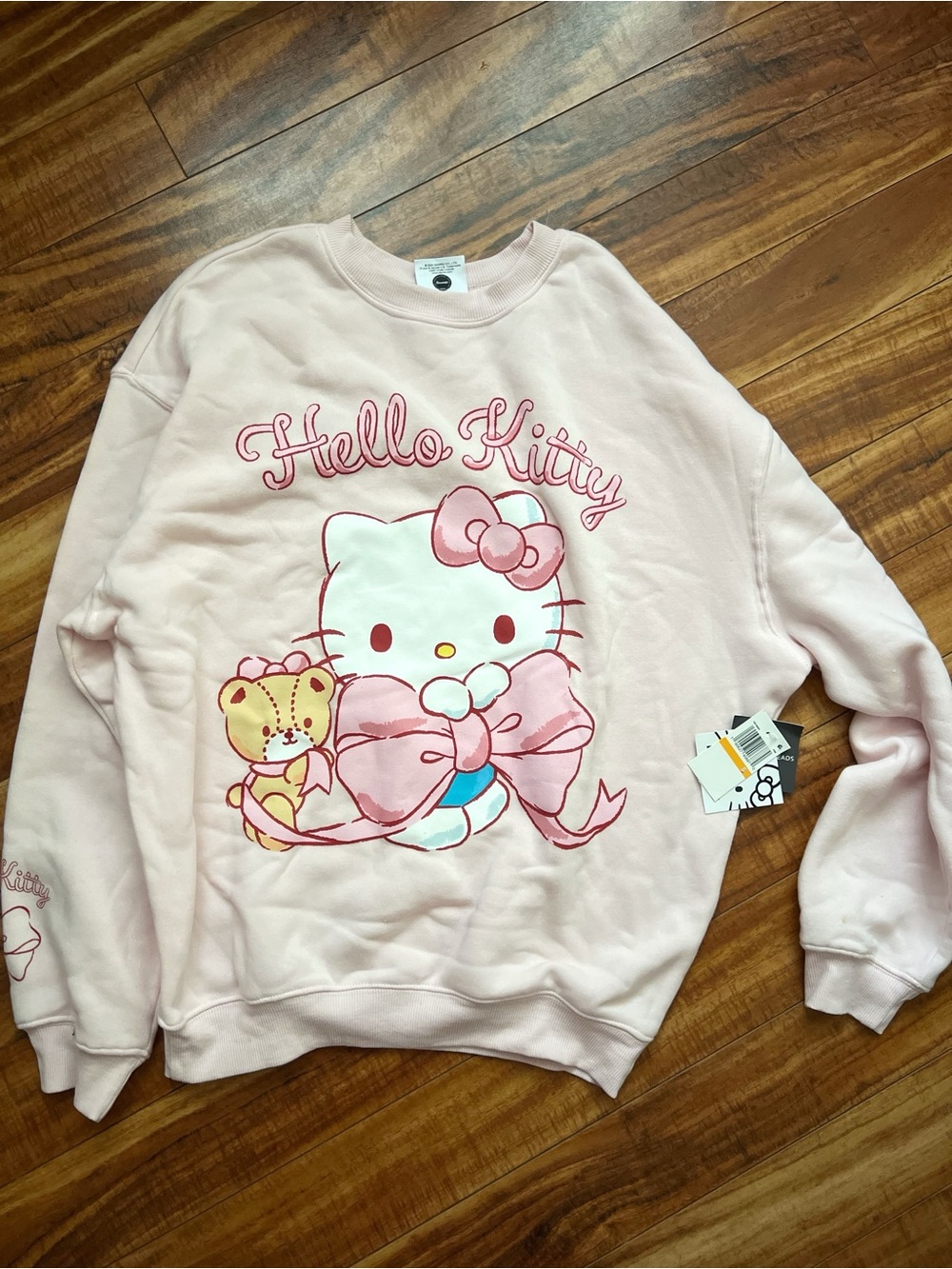 Sanrio Hello Kitty Light Pink Crewneck Sweatshirt with Bow Graphic